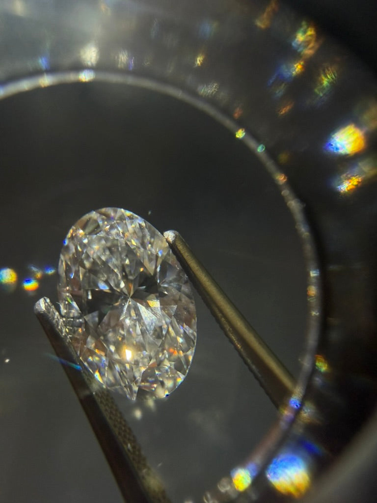 Oval diamond being evaluated during stone sourcing
