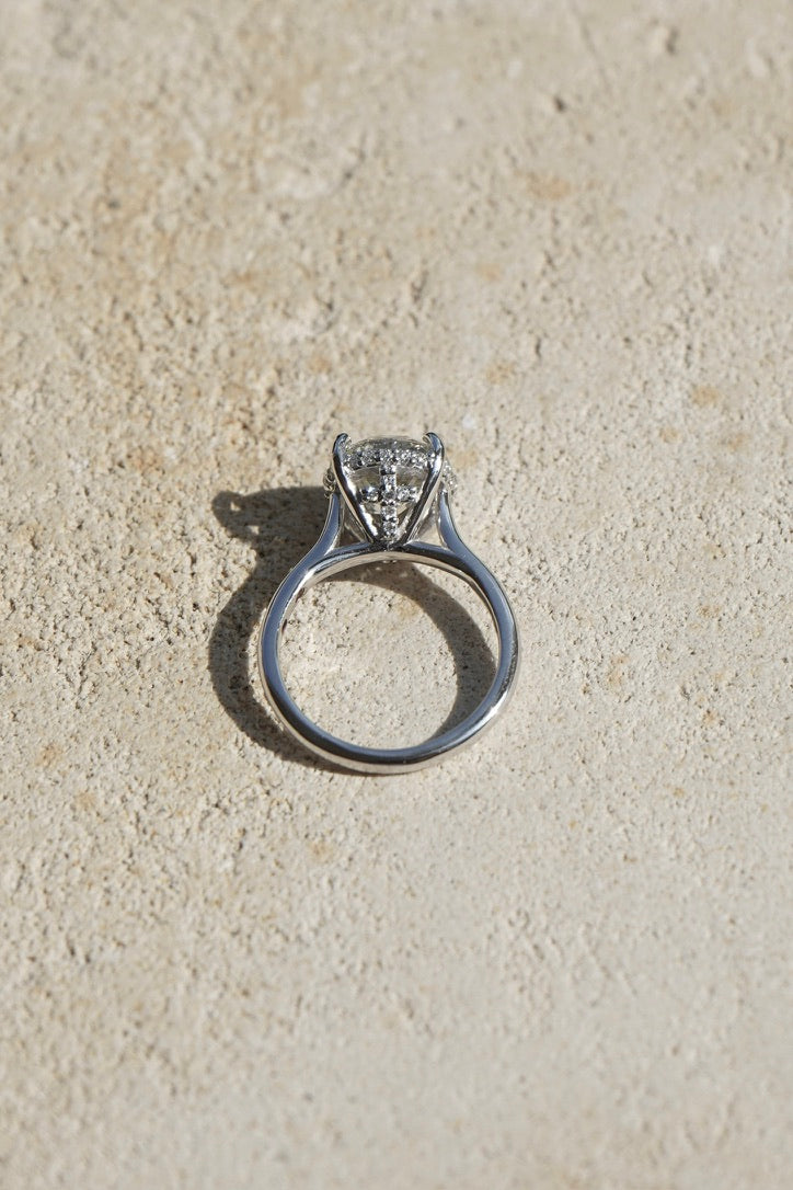 Side profile of a pear shaped custom engagement ring in white metal