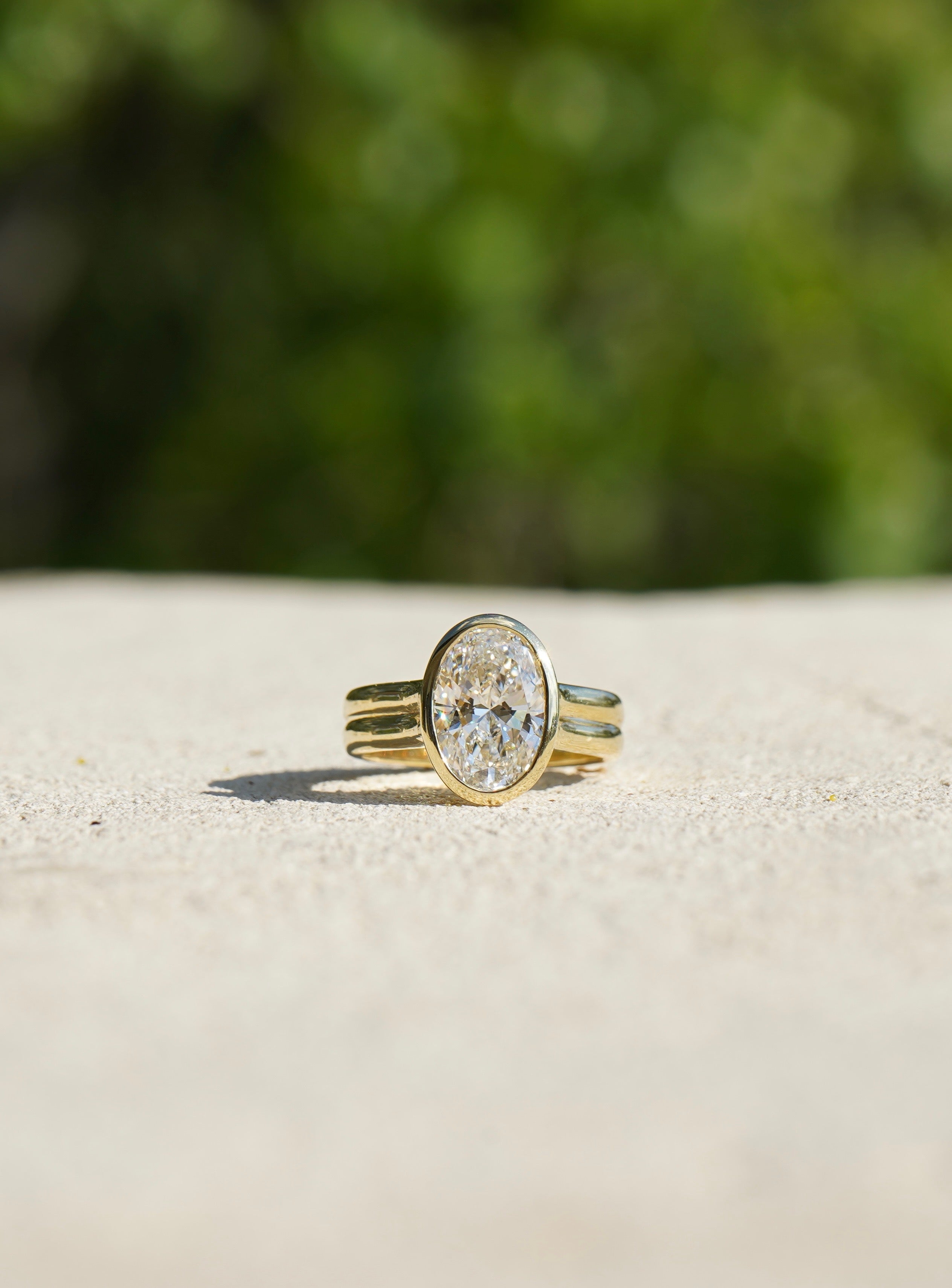 Landen and Taylor's oval diamond bezel set ring in yellow gold